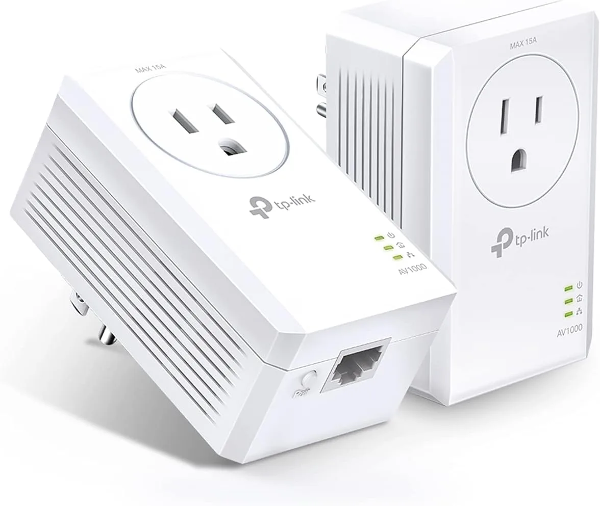 The two TP-Link TL-PA7017P powerline adapters from the starter kit, photographed against a white background, each a white wall-wart with a MAX 15A pass-through AC socket on its face, three status LEDs, an AV1000 label, a single Gigabit Ethernet port and a Pair button on the bottom edge